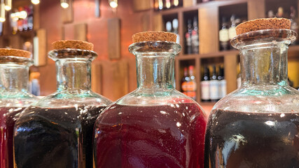 Decoction-filled vintage glass bottles, elixirs of midnight alchemy, evoking Samhain whispers and ancient festal gatherings