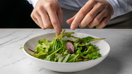 Diverse greens mingle in porcelain under careful European male hands, embracing the spirit of Tibb's Eve and Det strste maltid