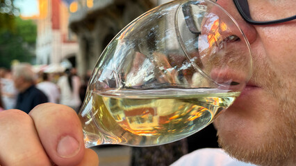 A contemplative moment with a crystal goblet of golden elixir, reminiscent of Bacchanalia whims and midsummer revelry