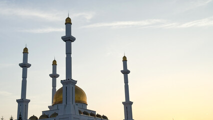 Golden domes glow against the dawn, evoking sacred silence, Eid al-Fitr whispers, crescent moon's...