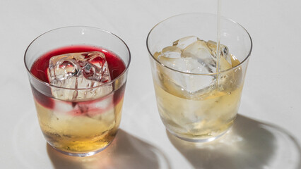 Two glasses gleam with icy libations, invoking a soiree of solstice spirits and the whimsical vibes of World Cocktail Day
