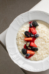 Creamy risotto with berry crown, a symphony of textures, perfect for Hygge gatherings or quirky International Porridge Day celebrations
