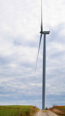 Majestic wind turbine dances in autumn breeze, casting whispers of Diwali light and La Tomatina's zestful aftermath