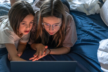 Girls at laptop. Top view. Shared watching