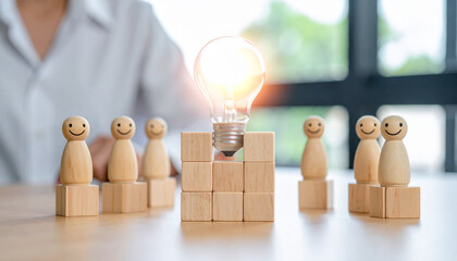 A brilliant idea concept featuring a lit light bulb atop blocks with wooden figures in the background