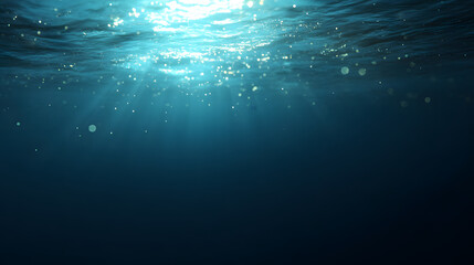 Sunlight streams through ocean waves, creating a mesmerizing play of light and shadow in deep blue waters.