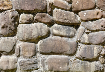 A wall made of stone with a rough texture