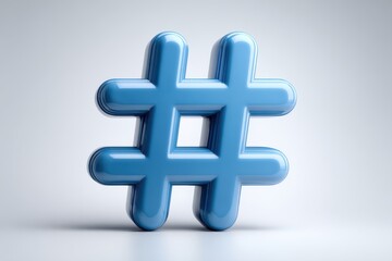 Obraz premium A shiny blue hashtag symbol floating in front of a gradient white to gray colored background studio shot