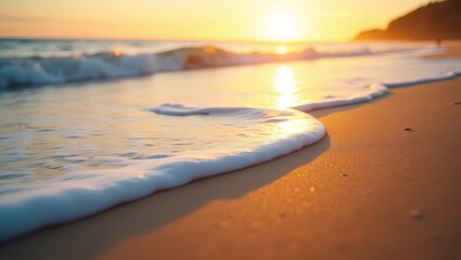 Obraz premium Golden sunlight bathes a soft wave cresting on a sandy beach at sunrise.