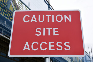 Obraz premium Close Up of Red Metal Road Sign 'Caution Site Access' 