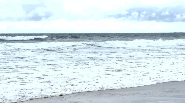 Ocean Waves Crashing on the Shore During Cloudy Weather..