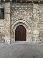 Obraz premium Stone arched entrance of La Asuncion Church in Quintanilla de Trigueros
