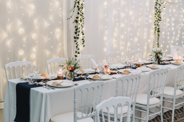 Romantic wedding dinner table with candlelight and floral centerpiece