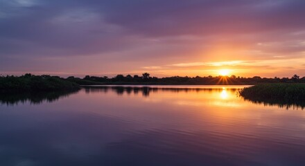 Obraz premium Serene Sunset Over a Calm Lake with Vibrant Colors