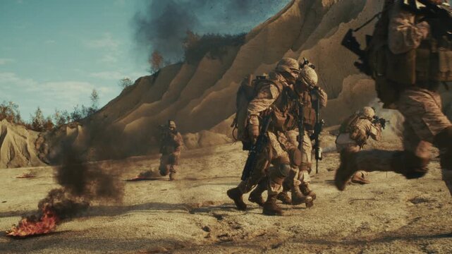Soldiers Running for Cover in an Ambush in the Desert. Fighting the War, Weapons Firing all around, Bombs and Rockets Explore. Modern Battlefield Warfare with Real Heroes. Intense Dramatic Handheld