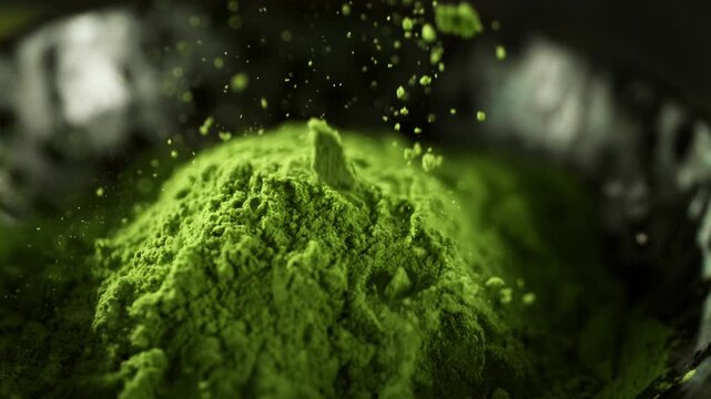 Super Slow Motion Detail Shot of Sprinkling Matcha Powder . Filmed on High Speed Cinematic Camera at 1000 FPS