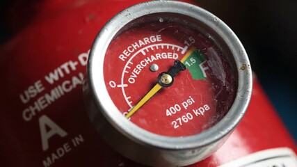 Close Up of Fire Extinguisher Pressure Gauge Showing Recharge Level on Red Cylinder