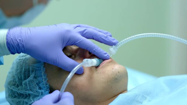 Close Up of Surgeon Performing Medical Procedure with Patient Intubated