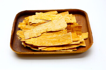 Dried Astragalus root slices used in traditional Chinese medicine.