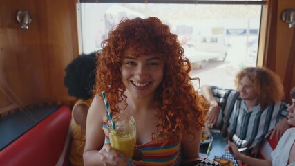 Multiethnic group of friends having meal at 80s vintage diner restaurant - Multicolored young people bonding and having fun, eating in an american fast food burger house	