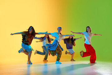 A diverse dance group embraces urban culture with vibrant expressions and team energy. Concept of multicultural performance and urban art celebration.