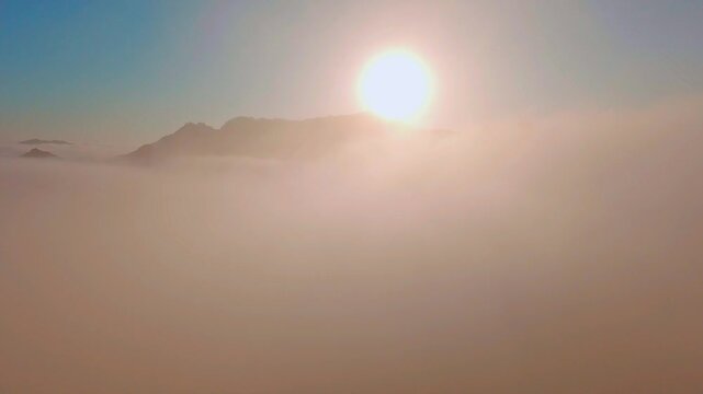 Malibu Mountain Summit at Sunrise &mdash; Ethereal aerial view of a peak rising above a sea of clouds