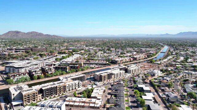 Aerial view of Scottsdale revealing a harmonious blend of urban structures and natural beauty under a clear sky, Scottsdale, Arizona, United States.