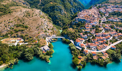 Italy tourism. Medieval scenic Barrea village and beautiful turquoise lake in Sangro Valley....