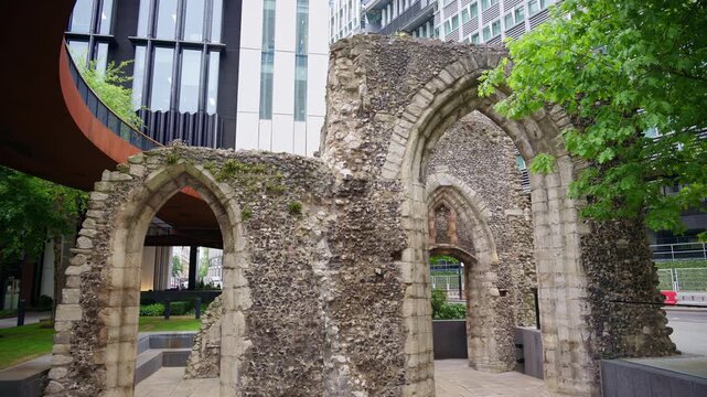 Close-up shot of ancient Roman wall ruins with modern office buildings located in the London Wall Place garden