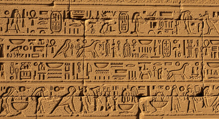 Naklejka premium Ancient Egyptian Hieroglyphs Carved on Stone Wall