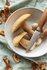 Fresh mushrooms with knife in bowl preparing for cooking