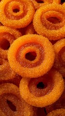 Bright orange imarti glossy sugar coating Indian dessert vertical wallpaper