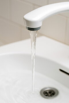 Water flowing from faucet in a bathroom