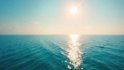 Obraz premium Vast, tranquil ocean stretching to the hazy horizon Sunlight glints on the calm water, creating a serene and peaceful atmosphere Perfect for travel, nature, and relaxation themes , ripple, blue