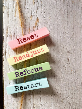 Reset readjust refocus restart text on adhesive note paper with copy space background. Stock photo.