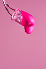 Magenta paint drop falling from led