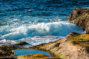 surf waves of clear blue waters of the Arctic Ocean