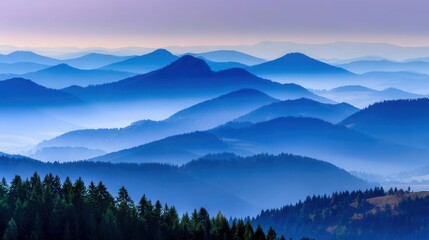 Obraz premium Misty mountain range with layers of blue hills