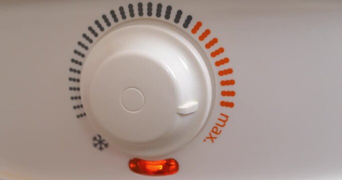 Temperature regulator for heating cold water in boiler. Red light indicator comes on - boiler has turned on to heat the water. Boiler heats water from cold water supply system