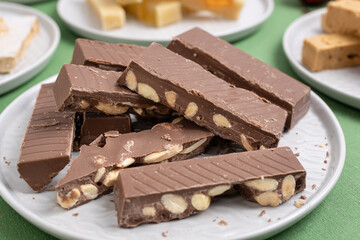 Close-up of a plate with chocolate with almonds turron , served on a Christmas table. A traditional Spanish sweet