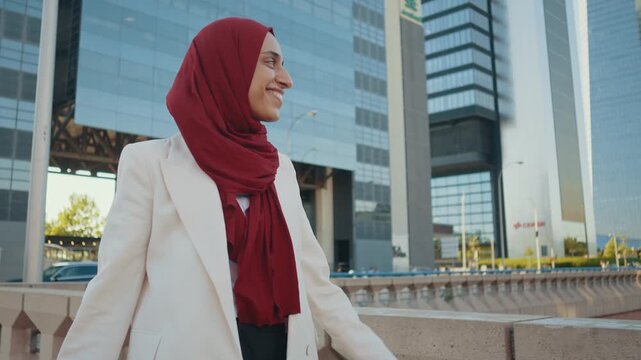 Professional businesswoman wearing hijab and white jacket on a business journey.