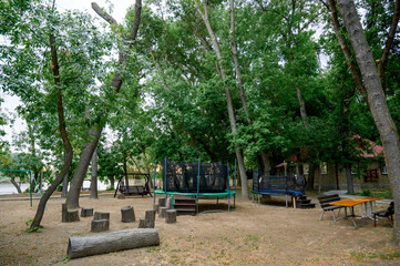Children's playground with a view of the house and slide in the park