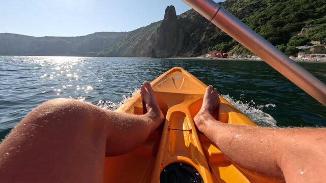 Kayak paddling ocean, person explores beautiful coastline on sunny day