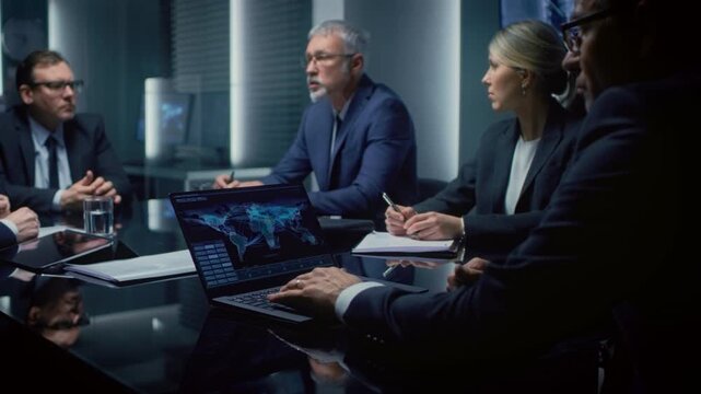 Executives Gather Around a Conference Table, Analyzing Global Data on Laptops and Discussing Strategic Objectives. Participants Take Notes, Review Charts, and Collaborate on Corporation Meeting Topic