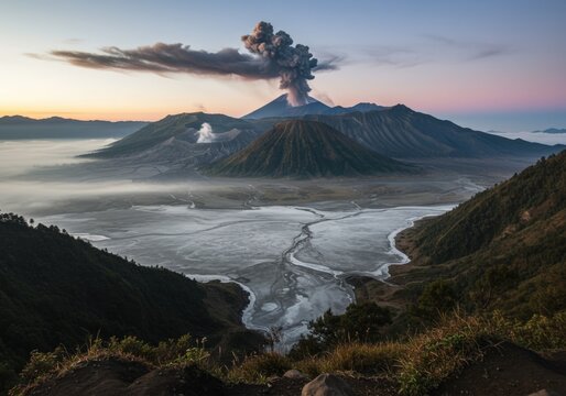 Dramatic landscape of Mount Bromo volcano in East Java, Indonesia. Volcanic smoke and ash clouds rise above the crater, surrounded by mist and mountains. Perfect for adventure, geology, and travel the