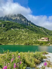 Scenic view of mountain lake and hut (Chata pri zelenom plese) in High Tatras, Slovakia. Zelene...