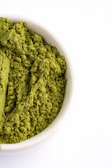 Henna, wheat grass or matcha powder on white background