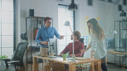 Young Professionals Engage in a Lively Office Discussion, Analyzing Data on a Computer. the Team Collaborates on a Project, Exchanging Ideas and Strategies for Digital Marketing Success.