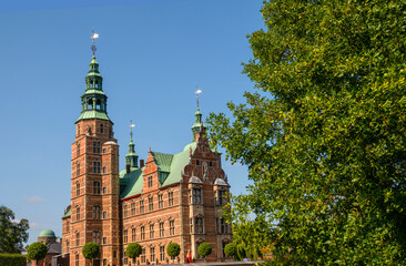 Obraz premium The fairy tale Rosenborg renaissance castle in Copenhagen, Denmark, seen from the Kings garden. The castle exhibits the Royal Collections including the Crown Jewels and regalia.