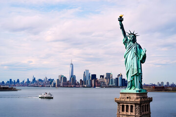 Statue of Liberty with New York City Skyline and Ferry on a Clear Day